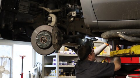 A mechanic works on a vehicle at Weed Family Automotive, a service shop in Concord.