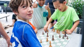 Children enjoying a game of chess in front of the St. Louis Chess Club during the 2019 Sinquefield Cup