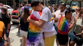 Magnus Juliano and Darius Golds embrace eachother at the New York City Pride Parade in 2019.