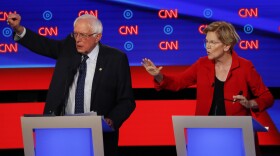 Sen. Bernie Sanders, I-Vt., and Sen. Elizabeth Warren, D-Mass., talk during in the first of two Democratic presidential primary debates hosted by CNN Tuesday, July 30, 2019, in the Fox Theatre in Detroit. (Paul Sancya/AP)