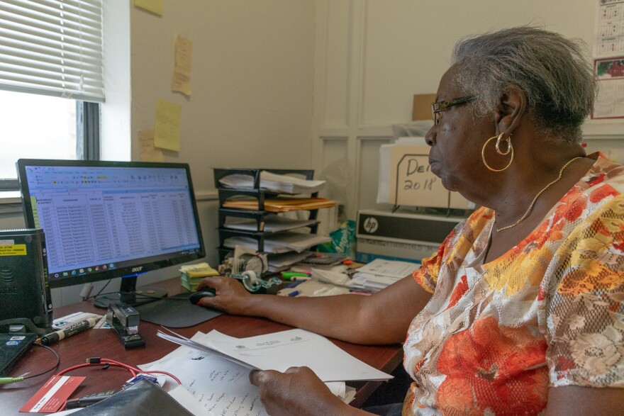 Delonia Winston shows a St. Louis Public Radio reporter one spreadsheet she keeps that tracks maintenance of Northside Regeneration-owned properties.