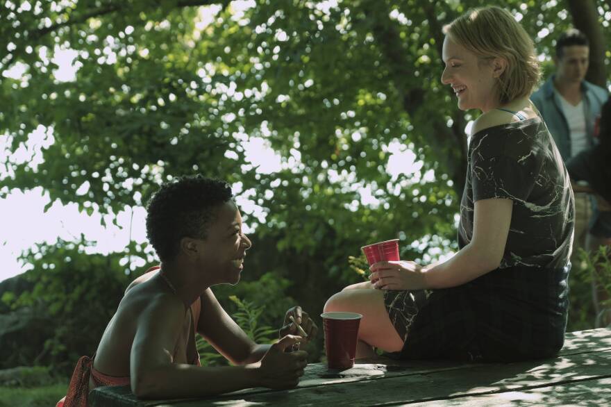 Moira (Samira Wiley, left) and Offred (Elisabeth Moss) are best friends "before Gilead." In flashbacks, their world seems normal — they go for jogs, talk about Uber and Tinder, and organize protests.