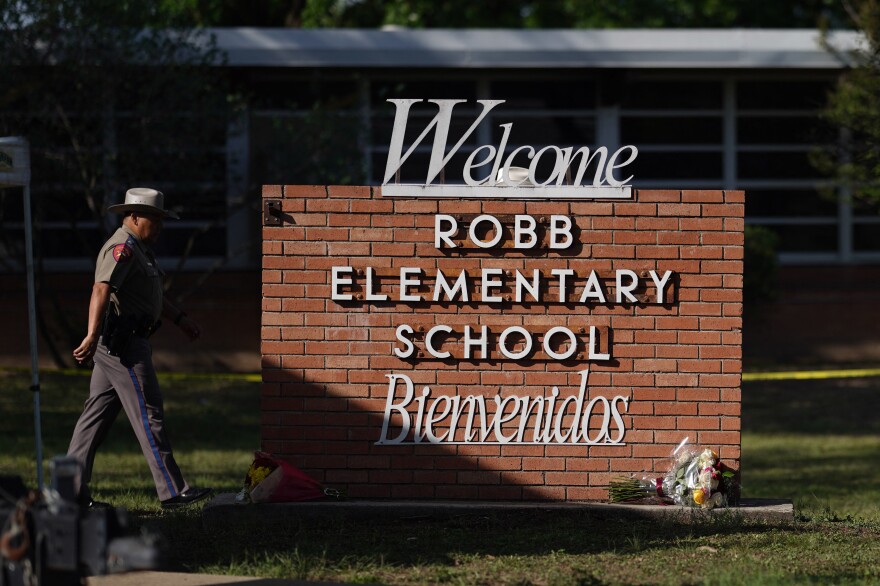 An officer walks outside of Robb Elementary School in Uvalde, Texas, on May 25. [Allison Dinner / AFP via Getty Images]