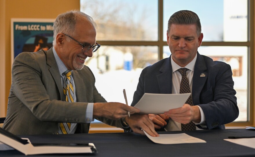 Misericordia President Daniel Myers and LCCC President John Yudichak sign a dual agreement between the schools.