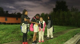 [From left to right] Cousins Tyjae Coston, Ri'yanna Hayes, Rh'niya Brown and Raynard Brown wait for their school bus on a corner in the Ninth Ward.
