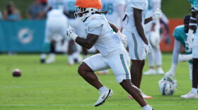 Former Miami Dolphins running back Anthony Hankerson does drills on a football field.