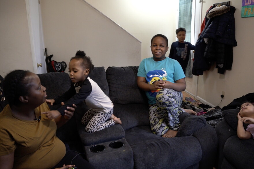 Eliza Carey (left) sits with her children. "This (expansion with monthly payments) is gonna make a big difference for a lot of families," she said.