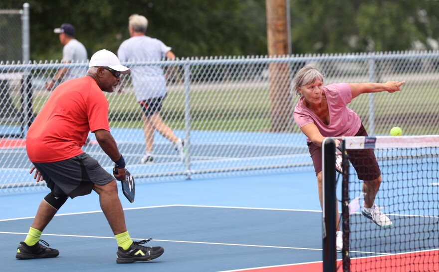 Jim Franklin of Fairport and Kate Savoca of Irondequoit play pickleball on what were two tennis courts at Fellows Road Park that have been turned into six new pickleball courts.