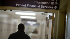 FILE: A sign points visitors toward the financial services department at a hospital.