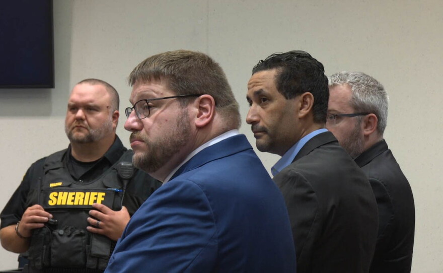 Luciano Frattolin is flanked by his lawyers as jurors announce their verdict