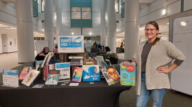 EMU STEM Librarian Kelly Getz stands in front of Halle Library's Banned Books Week display.