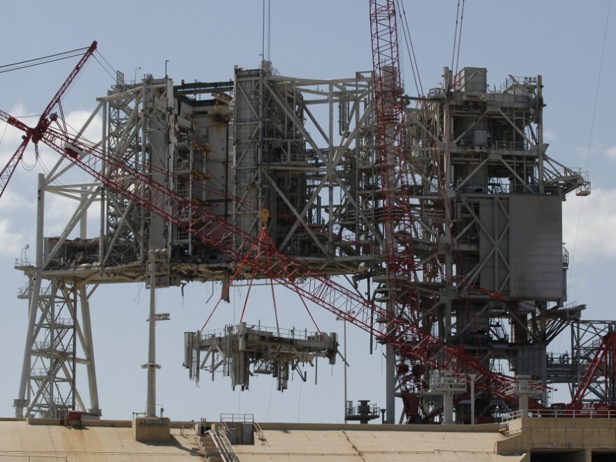 Cranes deconstruct a large section of the structure used to launch the space shuttles at launchpad 39B at Kennedy Space Center on April 6.