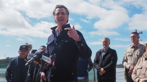 Gov. Gavin Newsom stands in front of flooded farm fields in Pajaro, CA and affirms that help from the state will continue. "You have my word on that," he said.