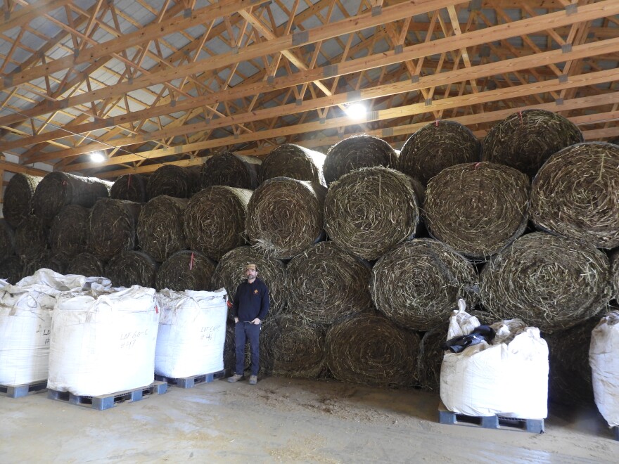 Matt Willse stands in front of hemp bales.