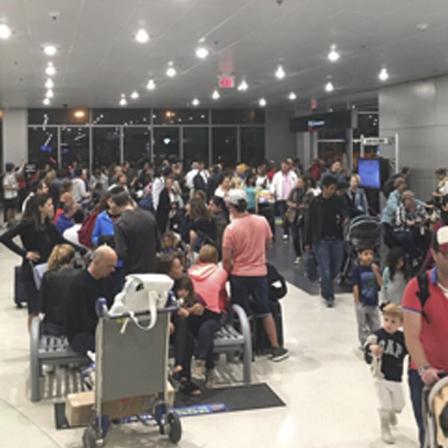 Miami's airport is packed on Thursday as residents and tourists evacuate the southern part of the state.