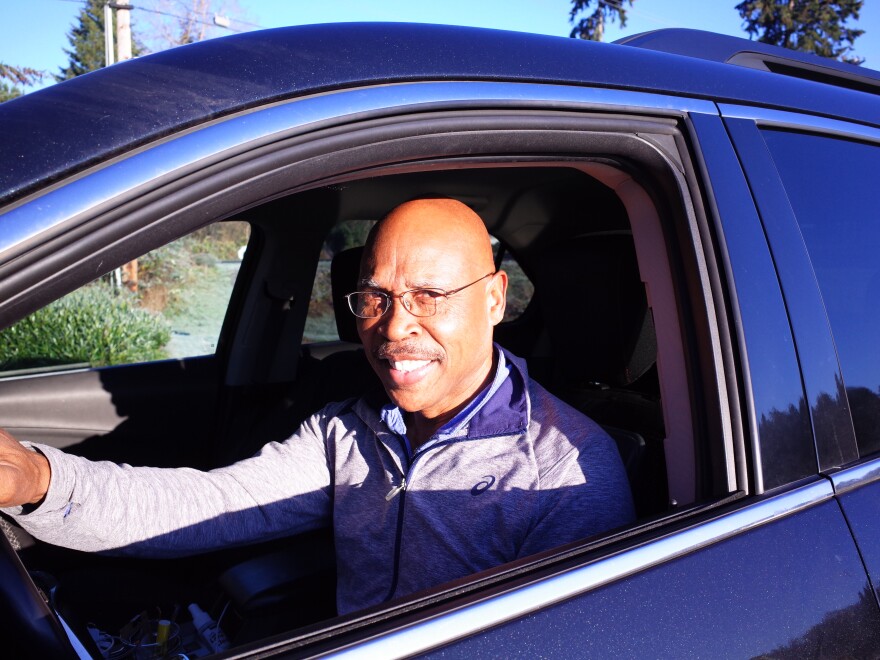 State Representative John Lovick in his car. The former state trooper and Snohomish County Executive offered to drive a reporter around in the early morning to demonstrate a particular form of suffering felt by commuters North of Seattle.