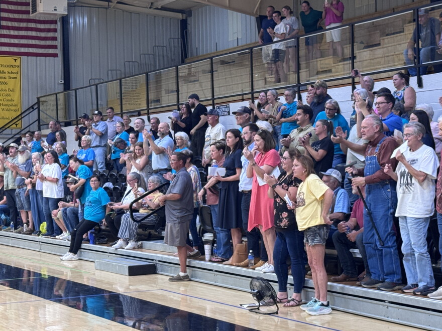 A crowd at Inola High School cheers after their local town council votes unanimously to pass a heavy industry moratorium until next April. At that time there will be a vote of the people to ultimately decide the fate of a massive smelter project in their community.