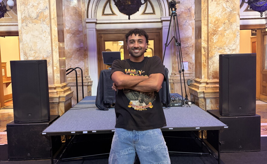 Milwaukee producer, Sunny Lou, stands in front of the stage in the Grand Rotunda of the Central Library ahead of The Library Show.