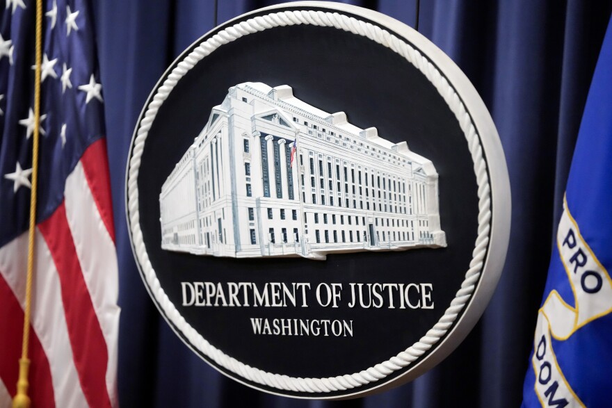 The logo for the Justice Department is seen before a news conference at the Department of Justice, Aug. 23, 2024, in Washington. 