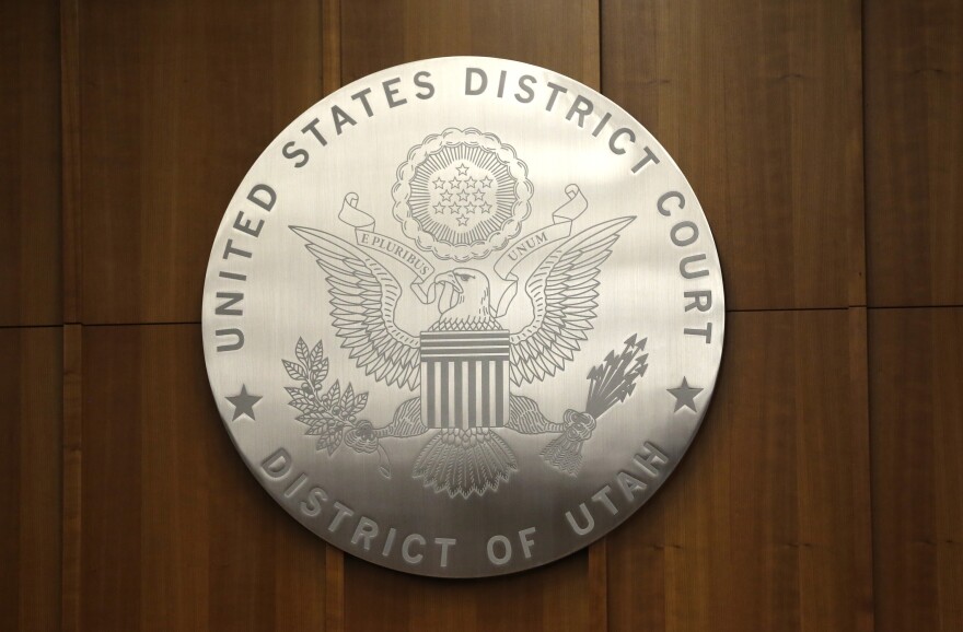 FILE – A United States District Court emblem is seen in a courtroom of the Orrin G. Hatch Federal Courthouse in Salt Lake City, April 9, 2014.