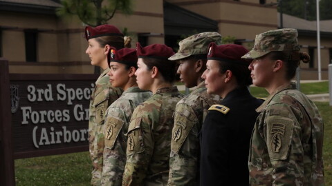 Six women stand in a line in military uniforms.
