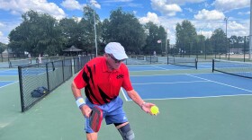 Roberts serving on a pickleball court at Kirklevington Park in Lexington