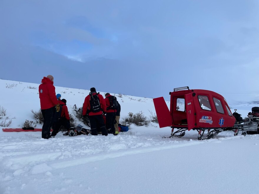 A Wasatch County Search and Rescue prepare to place a man who broke his femur while riding a snowmobile in a snowbulance.