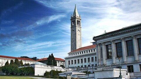 Photo of UC Berkeley taken on Memorial Glade, showing the Doe Memorial Library as well as Sather Tower (The Campanile) in the background