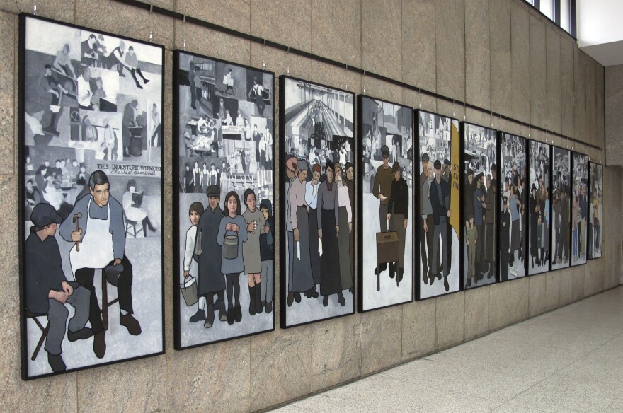 An 11-panel mural depicting the state's labor history is on public display in the atrium leading to the Maine State Museum on Monday, Jan. 14, 2013, in Augusta, Maine, after Gov. LePage ordered the panel removed from the Labor Department lobby in March 2011. 