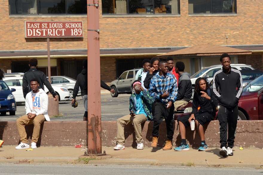 East St. Louis students spend about a month without school last fall due to a teacher strike. In this Oct. 1, 2015 file photo students spend their free day outside the school district office. 