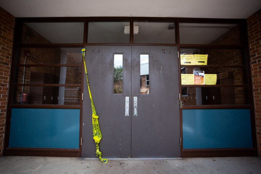 Caution tape hangs from the door of Crockett High School in South Austin last month. 