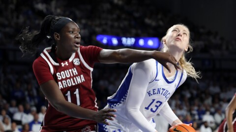Kentucky's Clara Strack (13) looks for a shot near South Carolina's Madina Okot (11) during an NCAA college basketball game in Lexington, Ky., Sunday, March 1, 2026. (AP Photo/James Crisp)