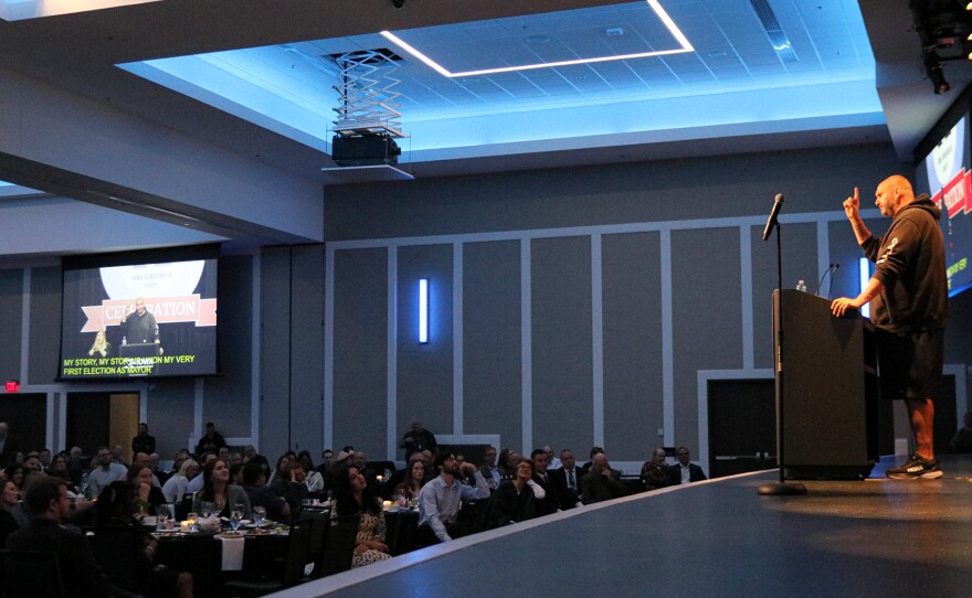 U.S. Senator John Fetterman (D-Pa.) speaks to a seated crowd at the Iowa Democratic Party's Liberty & Justice dinner.