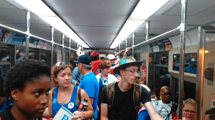 Delegates and protesters share a ride to the Democratic Convention Tuesday. Protesters were asked to disembark a stop before the convention.
