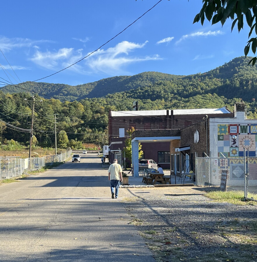 A man walks on Whitson Avenue in Swannanoa Monday. The Buncombe County Board of Commissioners took steps Tuesday to line up money to build, repair and replace sidewalks in Swannanoa’s historic business district.