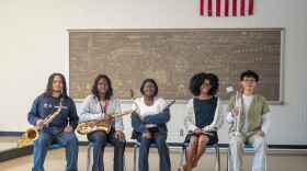From left: Nick Saunders, Roseneika Saint Jules, Cassietta Lewis, Tennia Gleplay, and Joshua Camero sit for a portrait with their instruments at Arsenal Technical High School on Monday, April 27, 2026, in Indianapolis.