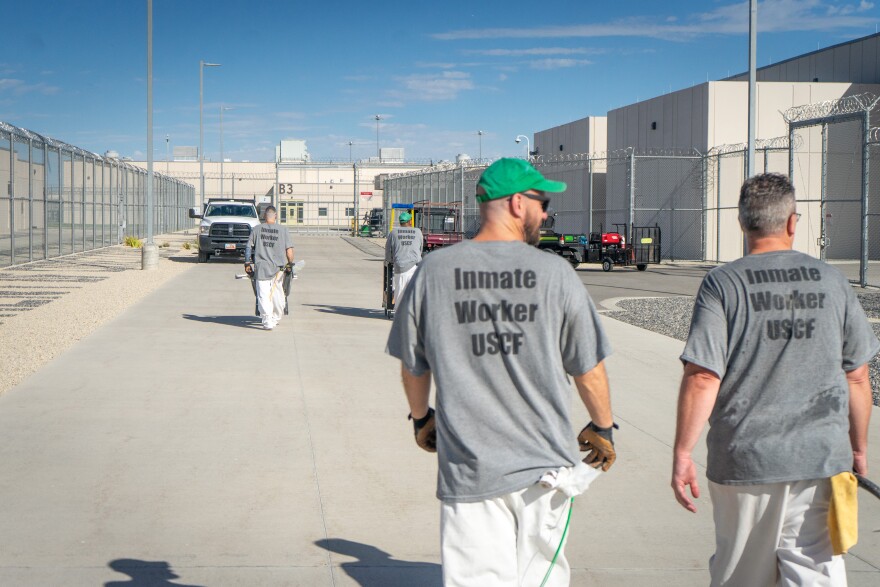 Ryan Parker and Alexander Wardell, inmates part of the landscaping work program, walk through the Utah State Correctional Facility.