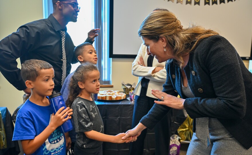 State Sen. Rosemary Brown, talks with twins Nyle and Norah, both 6, and their older brother Caleb Engerman, 9, at the grand opening of the Lackawanna County NAACP office. The children attended the event with their father, Jason Engerman.