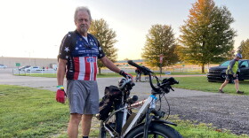 Howard Weaver stands beside his electric battery powered bicycle. This is his first DALMAC tour.