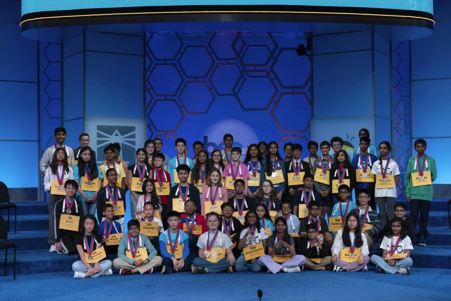 The 57 competitors who will move onto the semifinals pose for a official photo during the 100th Scripps National Spelling Bee at the Gaylord National Resort & Convention Center Wednesday, May 28, 2025, in Oxon Hill, Md. Lee County Spelling Bee champion and semifinal competitor Nicasio David is at left, rear.