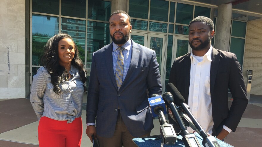 From left: K.C. Fox, Lee Merritt and Dominique Alexander stand outside of the Dallas Police Department headquarters on April 18, 2018.