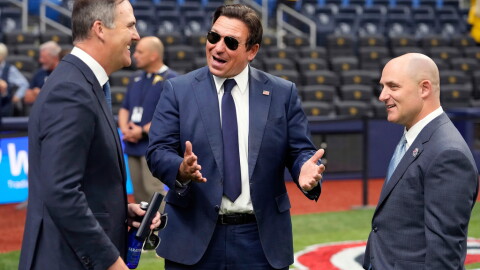  Gov. Ron DeSantis, center, talks to Rays managing partner/co-chair Patrick Zalupski, left, and Rays CEO Ken Babby before the home opener against the Chicago Cubs Monday, April 6, 2026.