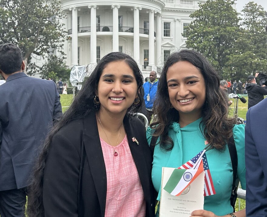 Shristi Sharma and Fedora Castelino standing on the lawn of the White House for an event in 2023 with Improve the Dream, a group that advocates for children of long term visa holders to help them stay in the U.S.