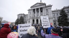 Attendees protest the one-year anniversary of Colorado's abortion law, the Reproductive Health Equity Act, Tuesday, April 4, 2023, outside the State Capitol in downtown Denver. 