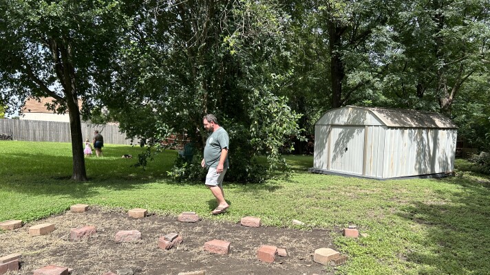 Will Burney surveys damage on his property Monday afternoon following the flash floods on June 14, 2026. The flooding, which Burney said has never caused this level of damage, displaced his storage shed and destroyed fencing in the Burneys' backyard.