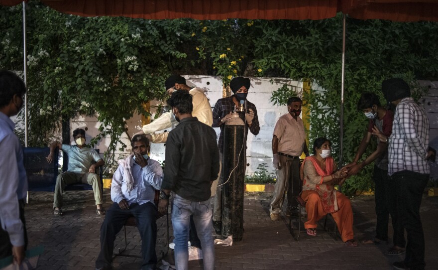 Volunteers provide free oxygen to COVID-19 patients at a makeshift clinic in a parking lot outside a Sikh house of worship on May 3 in New Delhi.
