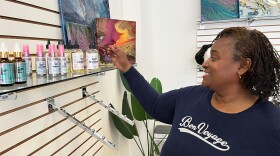 Candice Walker has been selling her Natural Rock’N hair care products online and at craft shows for years. Here, she sees them on a store shelf for the first time at Bloom Market. (Photo by Ryan Murphy)