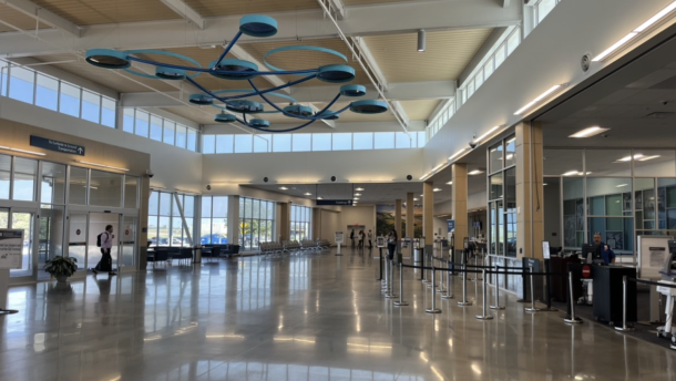 The inside of the Columbia Regional Airport. Passengers walk through the main lobby. 