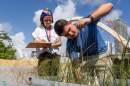 Juliana Grilo, program director at Frost Science Museum, and Nathan Rubin, a student at the University of Miami, record measurements of how tall sea oats are growing. A study hosted at Frost Science Museum found recycled glass sand grew sea oats as well as natural beach sand. Ashley Miznazi amiznazi@miamiherald.com