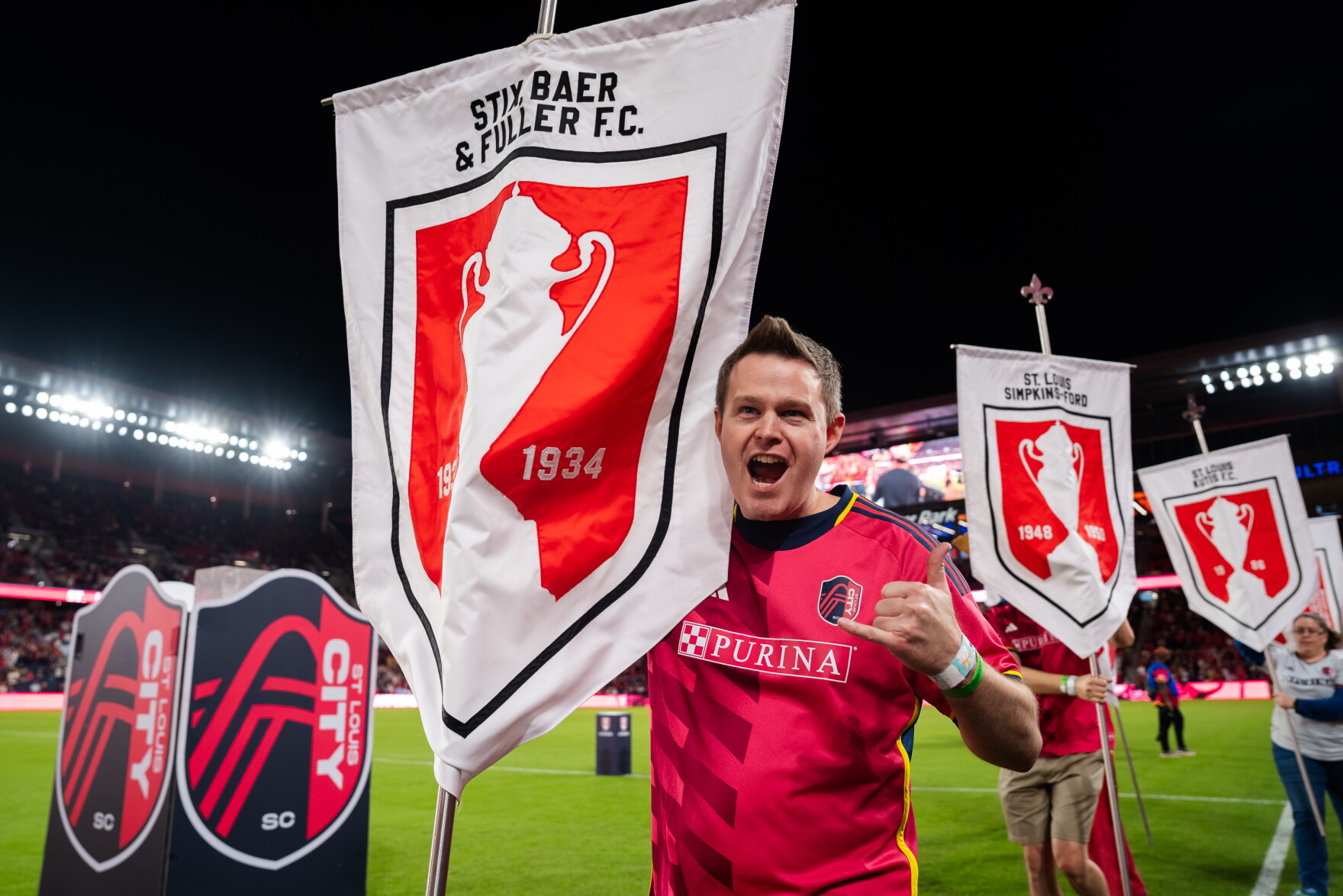 A St. Louis City SC supporter carries one of the banners honoring St. Louis’ 11 U.S. Open Cup titles during a pregame celebration on Wednesday, Oct. 28, 2026, at Energizer Park in St. Louis’ Downtown West neighborhood.